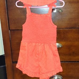 Orange sleeveless short romper with matching bucket hat